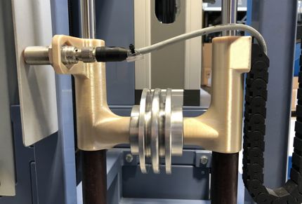 RUSTIN deploys its Fortus 450mc to create internal production-line tooling. The photo shows a weight optimization tool produced in ULTEM™ 9085 resin.