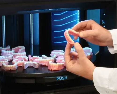 dentajet xl hands holding 3d printed dentures