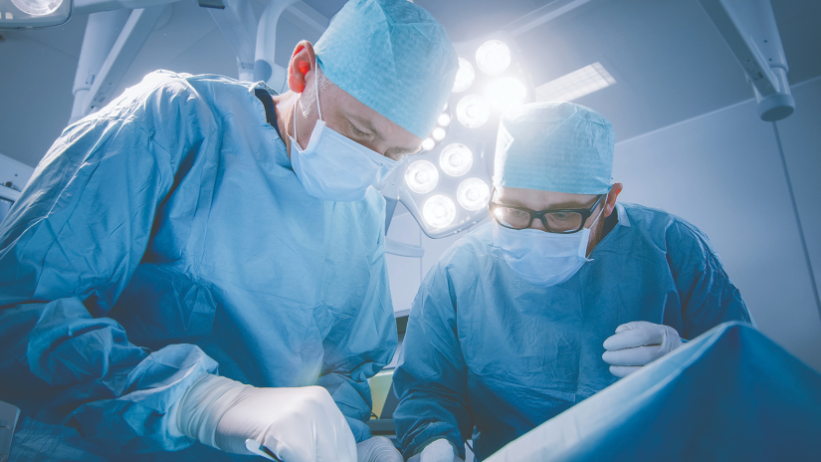 Surgeons working on brain tumor patient. 