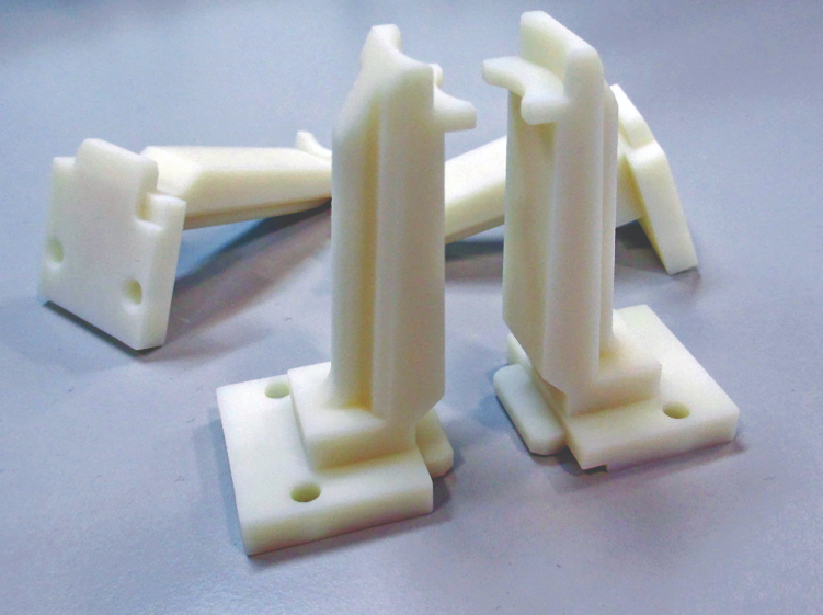 3D printed handling fixture in VeroWhite material. Installed on a robot, this manufacturing tool enables the team to lift the caps on the rigid packaging during production.