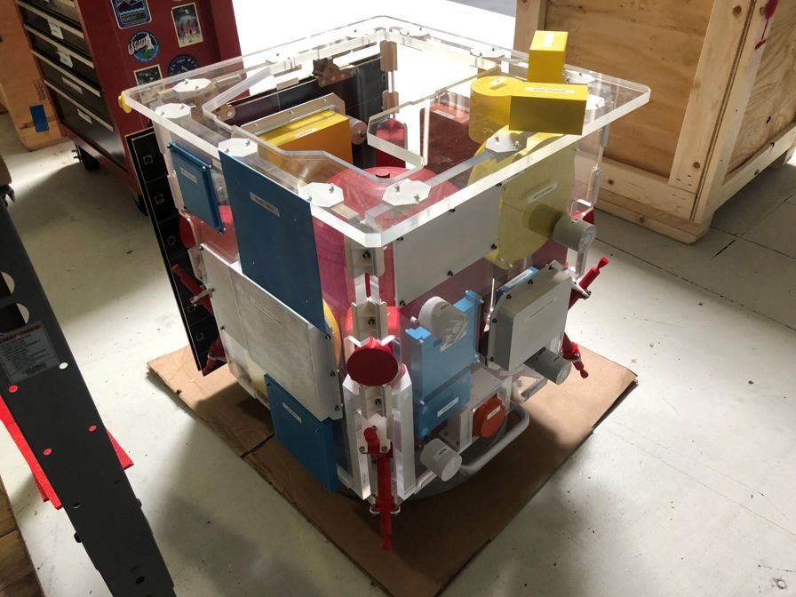 The colored components are 3D printed simulators being used for a fit-check mock-up.