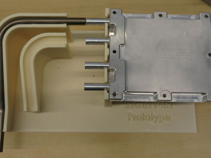 This 3D printed tool aligns the tube to be welded to the housing.