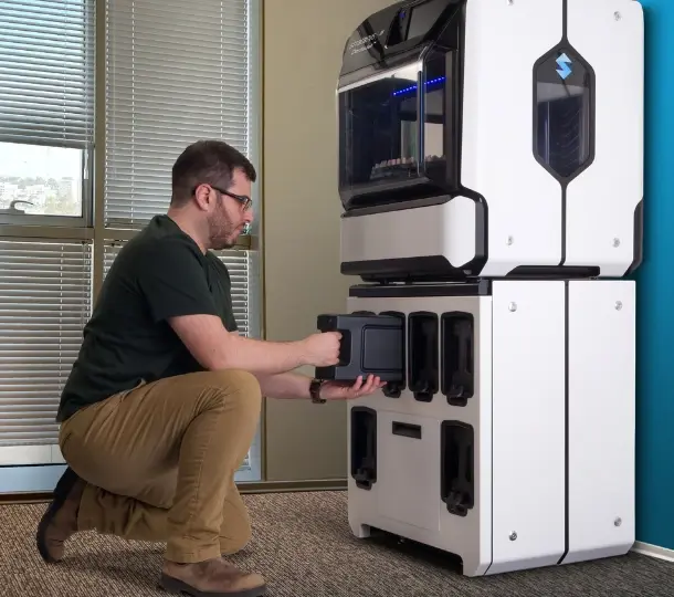 Dental lab technician servicing printer