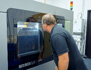 Man standing in front of F900 3D printer