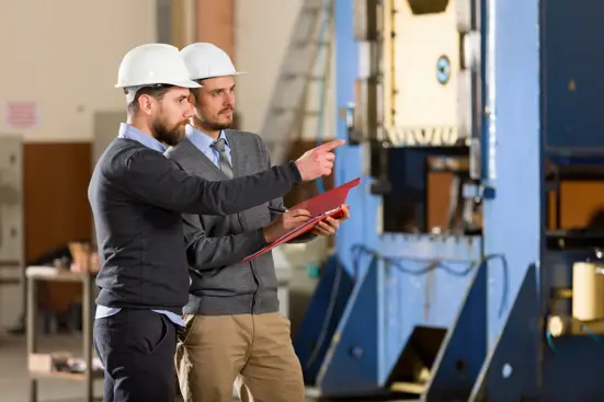 Engineers reviewing production schedules on-site.
